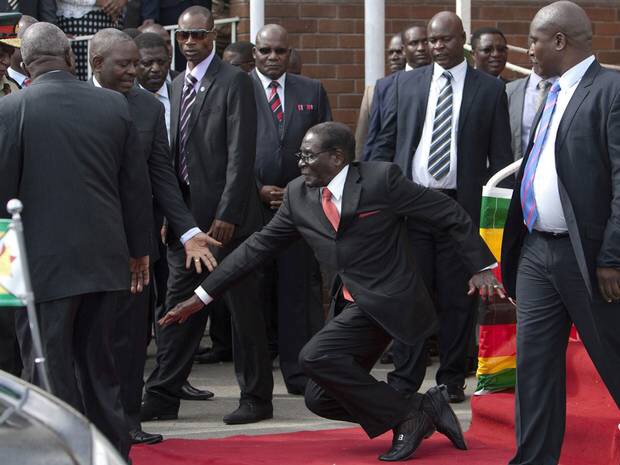 Robert Mugabe falls down stairs, tries to get photographers to delete the film