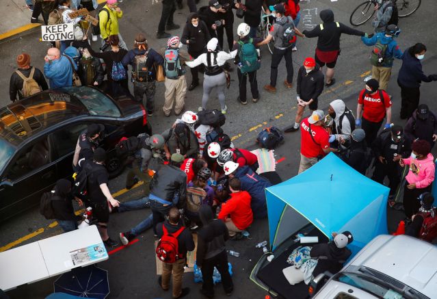 Man drives into Seattle protest, shoots protester