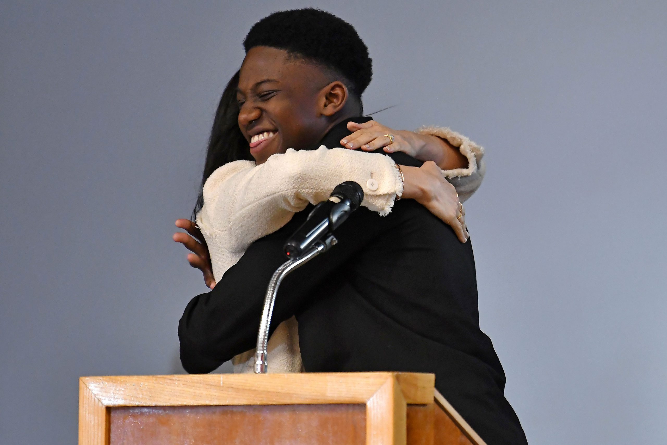 British schoolboy Aker Okoye  hugs Duchess of Sussex Meghan, says ‘sorry Harry’