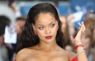 Rihanna poses in a metallic bikini and lace-up gladiator heels