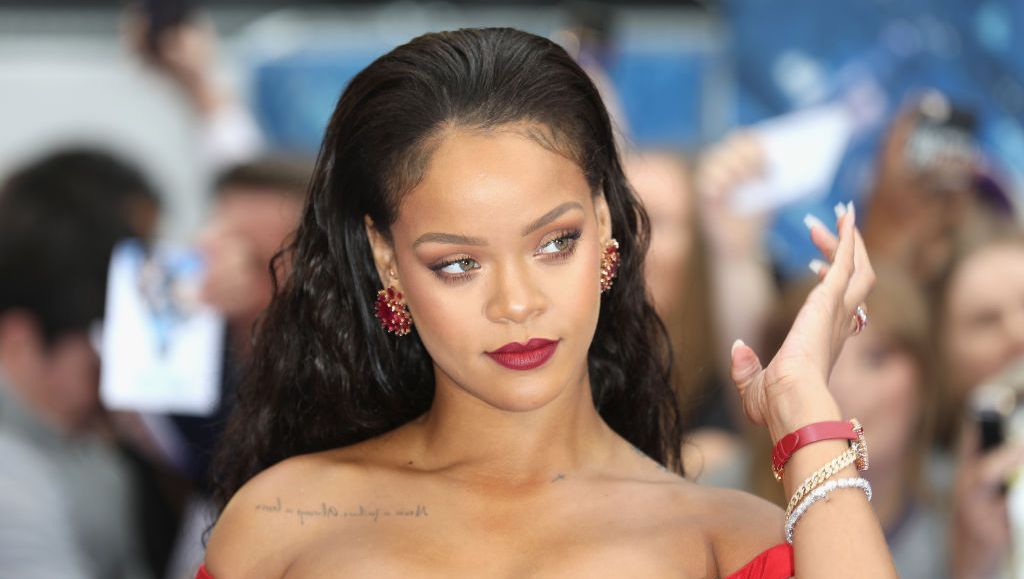 Rihanna poses in a metallic bikini and lace-up gladiator heels